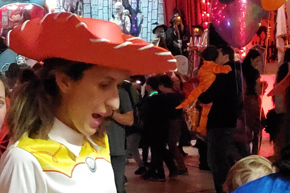 Woman dressed as Woody from Toy Story talking