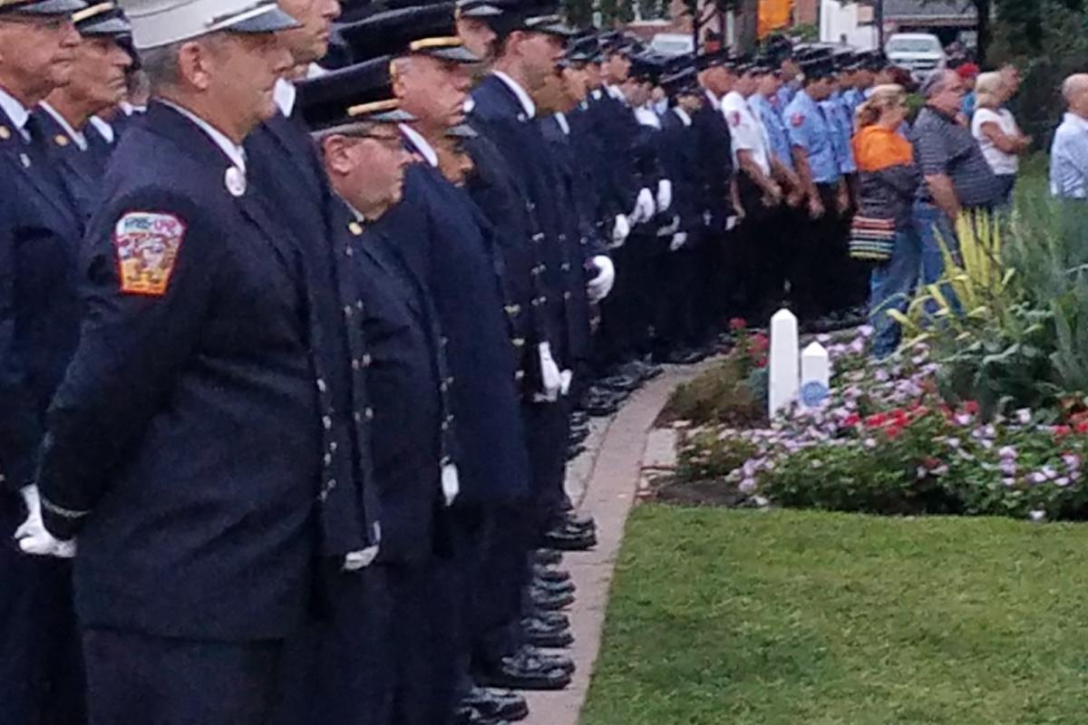 Mineola Fire Department members in uniform standing lined up